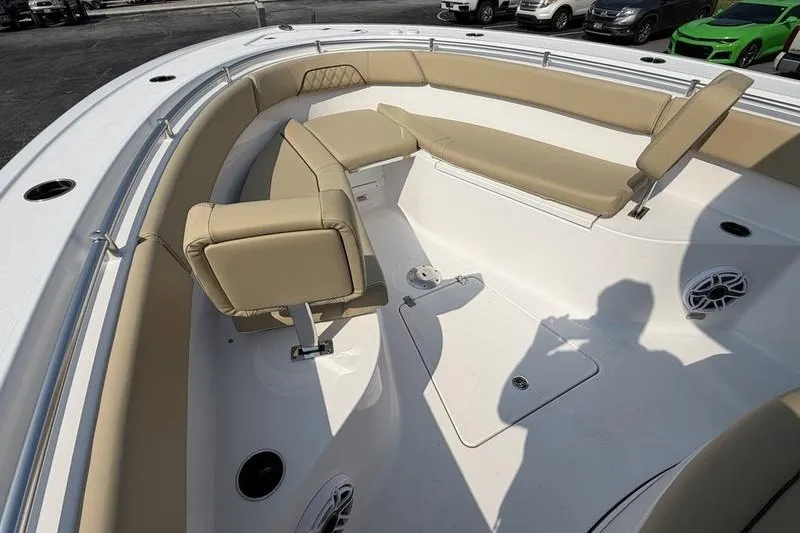 Slide: The Image of 2027 Sportsman Open 262 Center Console boat interior with beige seating and white deck. - 28