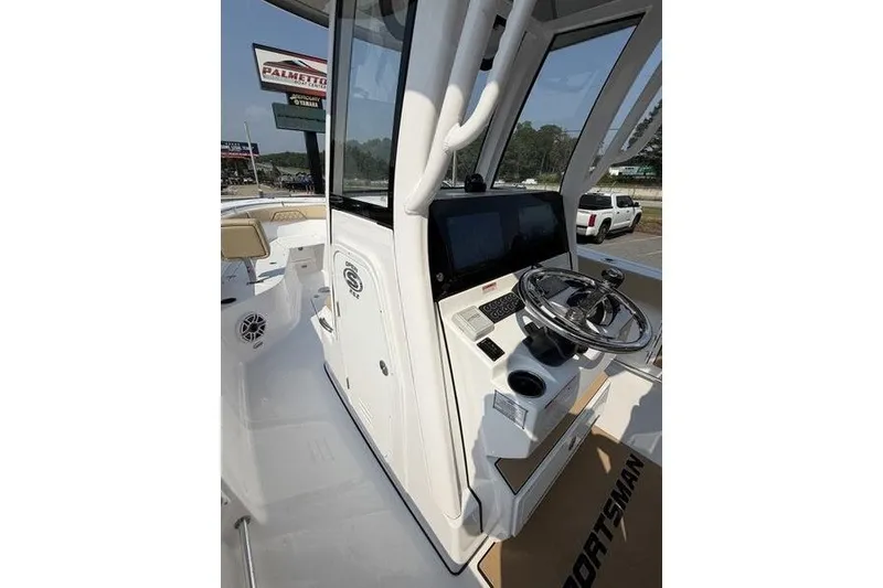 Slide: The Image of 2027 Sportsman Open 262 Center Console boat interior with steering wheel and control panel. - 24