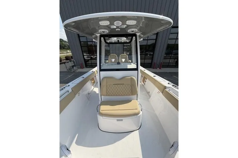 Slide: The Image of 2027 Sportsman Open 262 Center Console boat with tan seating and T-top. - 1