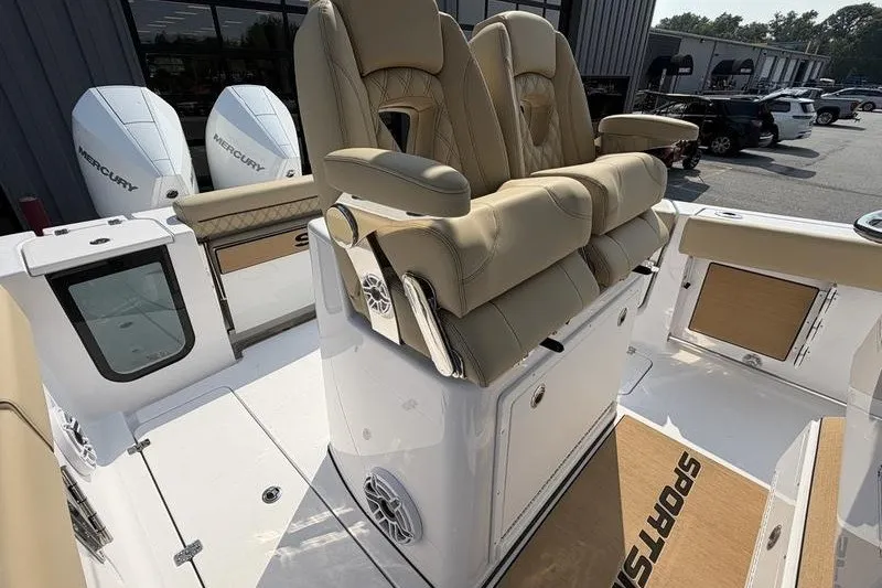 Slide: The Image of 2027 Sportsman Open 262 Center Console with beige seating and dual Mercury engines. - 21