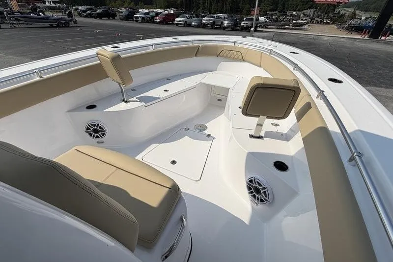 Slide: The Image of 2027 Sportsman Open 262 Center Console boat interior with beige seating and speakers. - 17