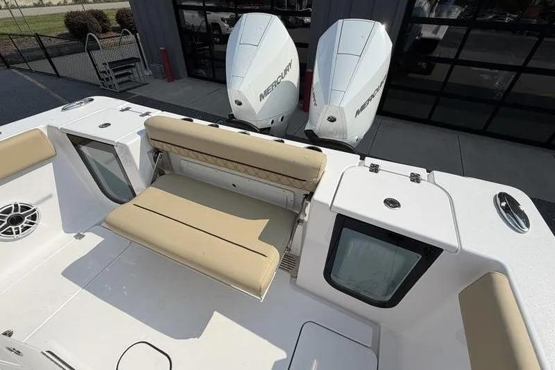 Slide: The Image of 2027 Sportsman Open 262 Center Console with dual Mercury engines and beige seating. - 4
