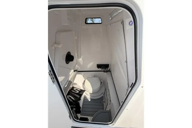 Slide: The Image of Interior of 2027 Sportsman Open 262 Center Console boat's compact bathroom. - 7