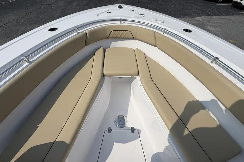 Slide: The Image of 2027 Sportsman Open 262 Center Console boat with beige seating and spacious deck. - 9