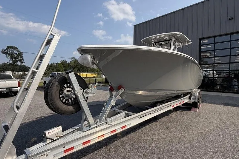 Slide: The Image of 2027 Sportsman Open 262 Center Console boat on trailer outside a building. - 20