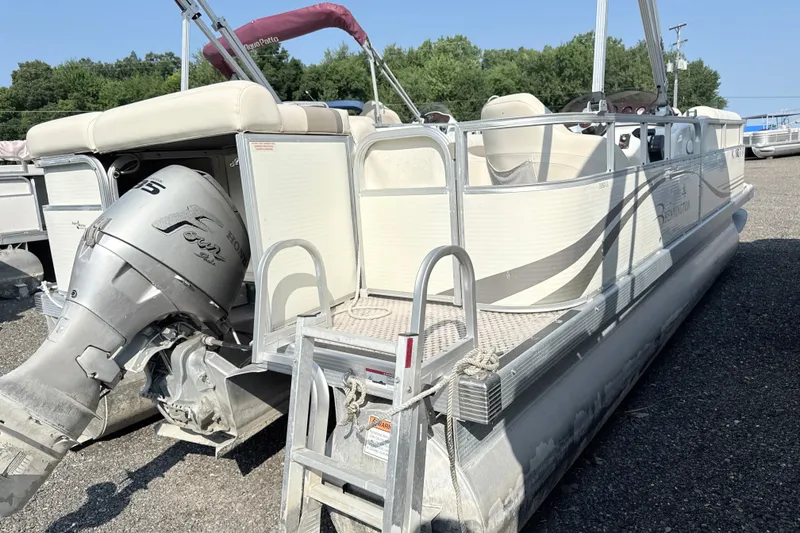 Slide: The Image of 2006 Bennington 2050GL pontoon boat with Honda outboard motor, parked on gravel. - 9