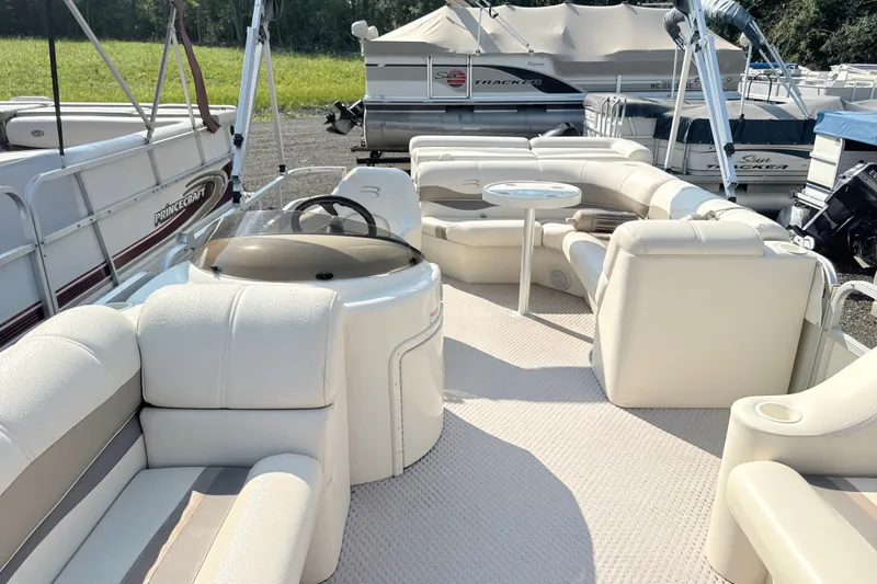 Slide: The Image of 2006 Bennington 2050GL pontoon boat with beige seating and steering console. - 8
