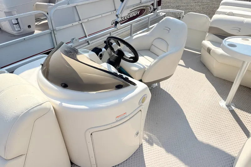Slide: The Image of 2006 Bennington 2050GL boat interior with steering console and seating area. - 11