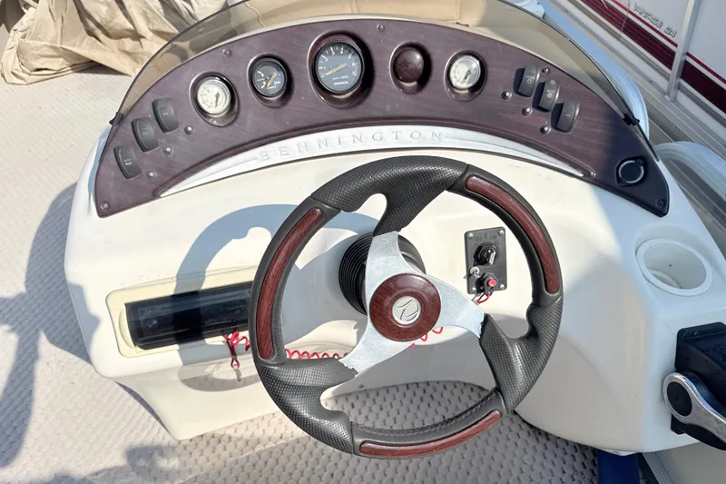 Slide: The Image of Steering console of a 2006 Bennington 2050GL boat with gauges and controls. - 14