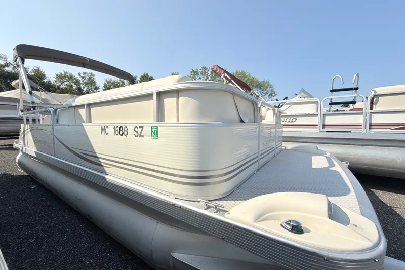 Slide: The Image of 2006 Bennington 2050GL pontoon boat with canopy, docked outdoors on a sunny day. - 6