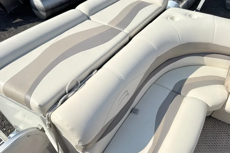 Slide: The Image of 2006 Bennington 2050GL boat interior with beige and gray seating. - 16