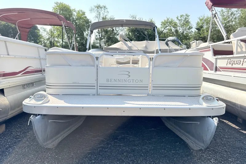 Slide: The Image of 2006 Bennington 2050GL pontoon boat, docked with canopy, surrounded by trees. - 3