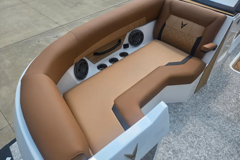 Slide: The Image of The image shows a luxurious boat seat with brown and beige upholstery, speakers, and cup holders. - 14