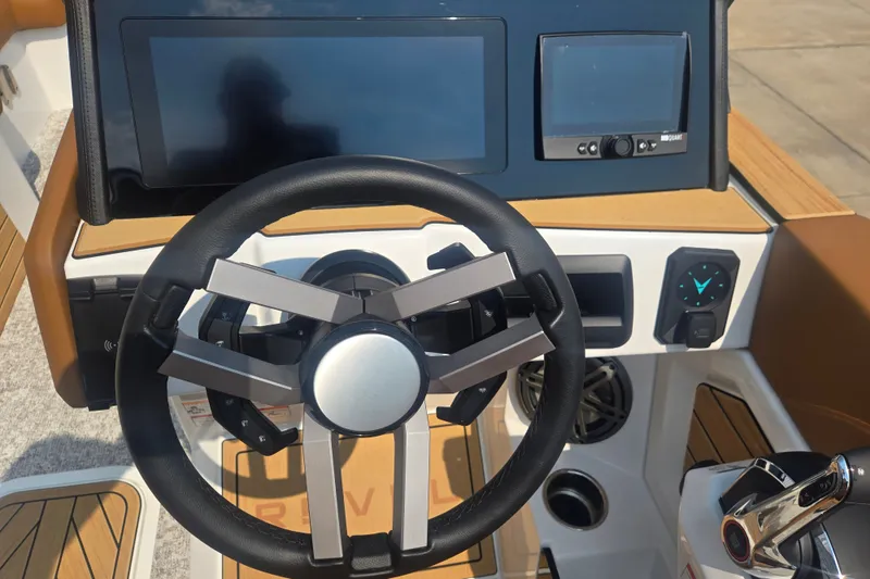 Slide: The Image of The image shows the cockpit of a 2027 Revel RL23 with a modern steering wheel and electronics. - 8