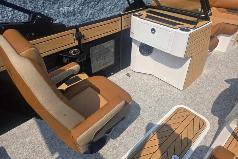 Slide: The Image of The image shows the interior of a Revel RL23 boat with beige and brown seating. - 10