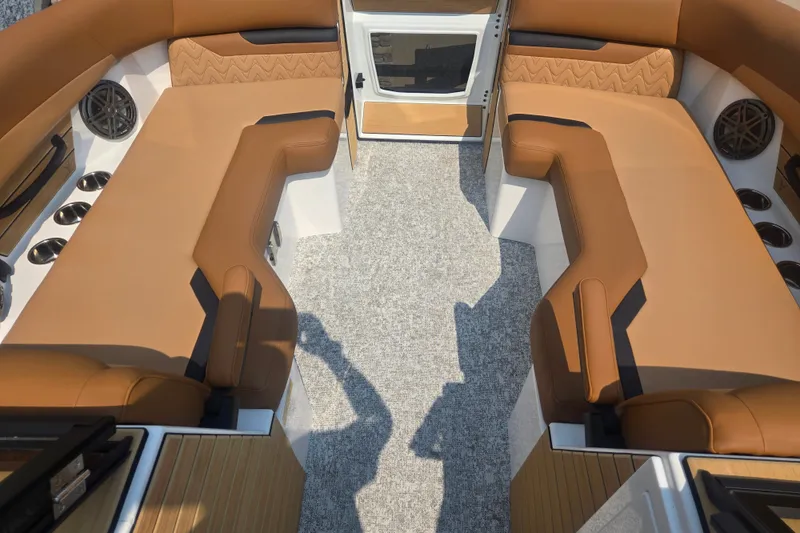 Slide: The Image of Interior of a 2027 Revel RL23 with brown upholstery and carpeted floor. - 5