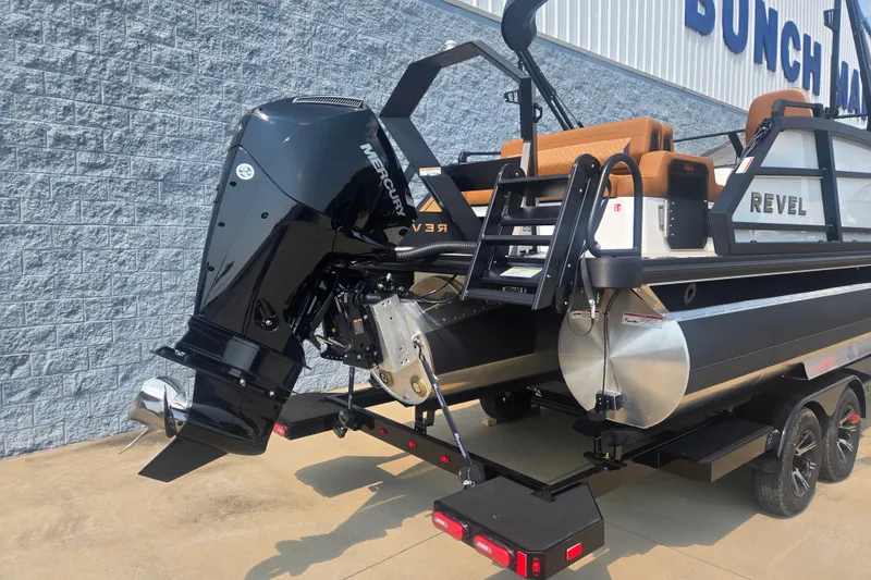 Slide: The Image of The image shows a modern boat with a powerful outboard motor, sitting on a trailer. - 1