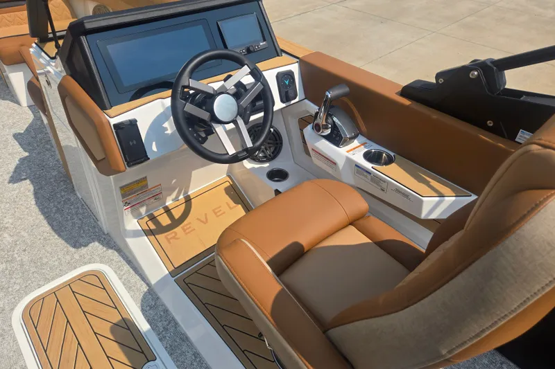 Slide: The Image of The cockpit of a 2027 Revel RL23 with brown leather seats and modern controls. - 9
