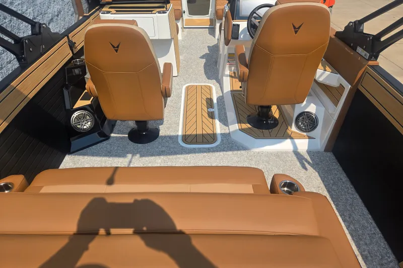 Slide: The Image of The image shows the interior of a Revel RL23 boat with brown leather seats and modern controls. - 6