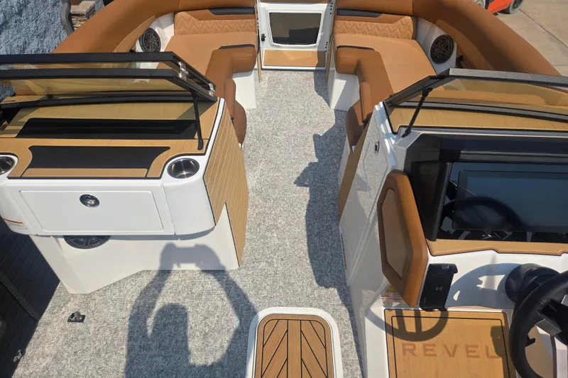 Slide: The Image of The image shows the interior of a 2027 Revel RL23 boat with brown seating and modern controls. - 7