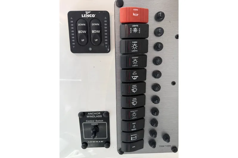 Slide: The Image of Control panel of 2024 Parker 2320 Sport Cabin with switches for lights, horn, and trim tabs. - 14