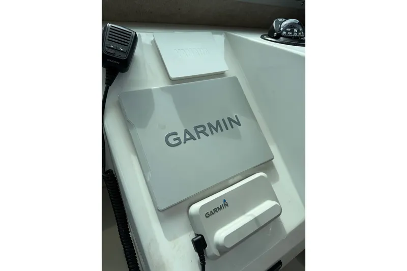 Slide: The Image of 2024 Parker 2320 Sport Cabin dashboard featuring Garmin navigation equipment. - 13
