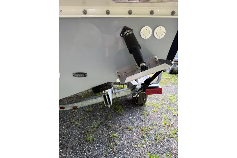 Slide: The Image of 2024 Parker 2320 Sport Cabin boat trailer hitch and trim tab detail. - 5