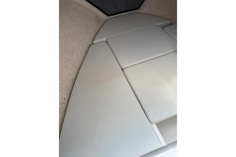 Slide: The Image of 2024 Parker 2320 Sport Cabin interior with white cushioned seating. - 12