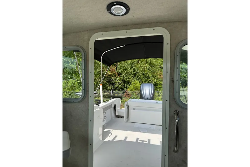 Slide: The Image of 2024 Parker 2320 Sport Cabin interior view with open door to deck. - 18