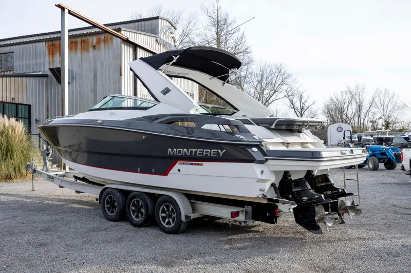 Slide: The Image of 2015 Monterey 328SS Super Sport boat on trailer, parked outdoors. - 6