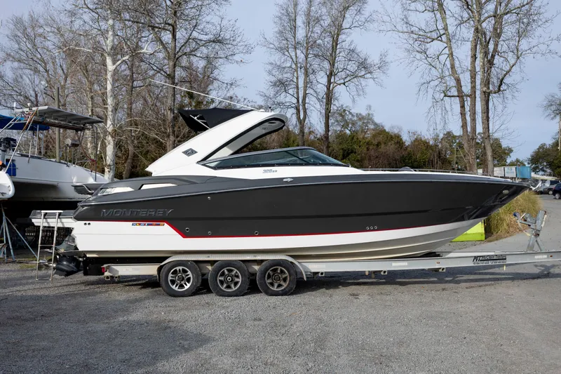 Slide: The Image of 2015 Monterey 328SS Super Sport boat on trailer, parked outdoors. - 2