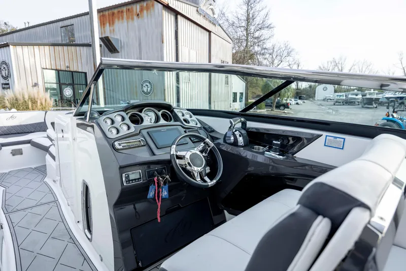 Slide: The Image of 2015 Monterey 328SS Super Sport boat interior with modern dashboard and steering wheel. - 15