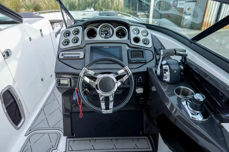 Slide: The Image of Cockpit of 2015 Monterey 328SS Super Sport boat with modern controls and steering wheel. - 16