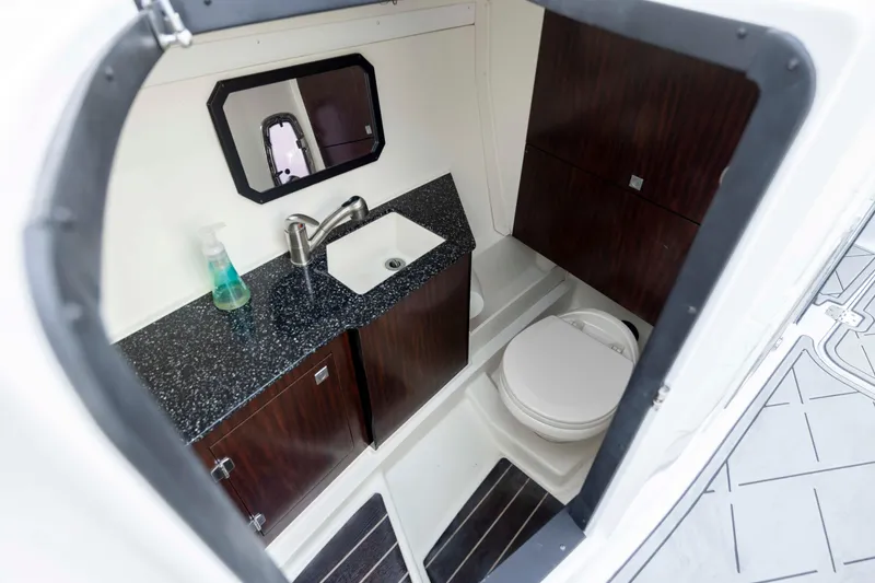 Slide: The Image of 2015 Monterey 328SS Super Sport boat bathroom with sink, toilet, and mirror. - 24