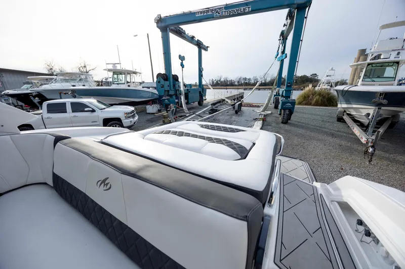 Slide: The Image of 2015 Monterey 328SS Super Sport boat on trailer at marina with other boats. - 10