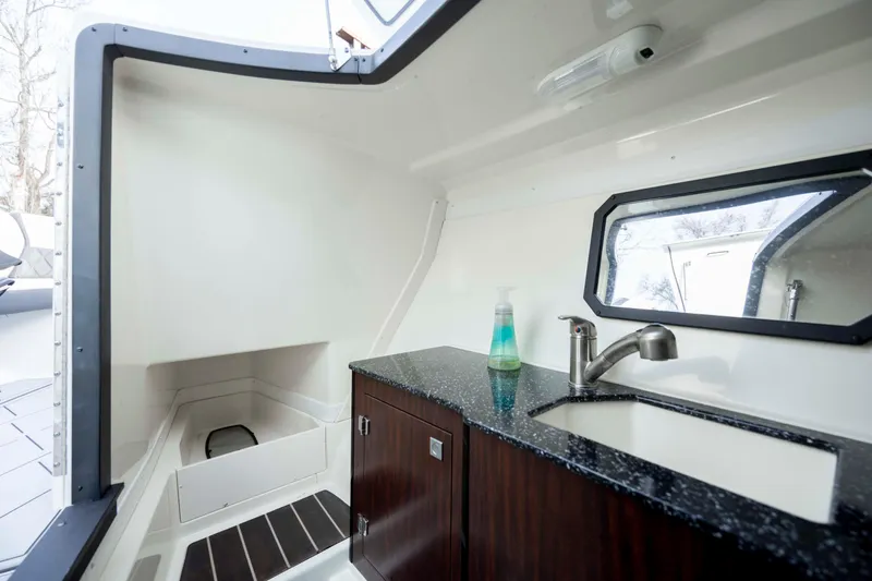 Slide: The Image of Interior of 2015 Monterey 328SS Super Sport boat with sink and storage cabinet. - 26