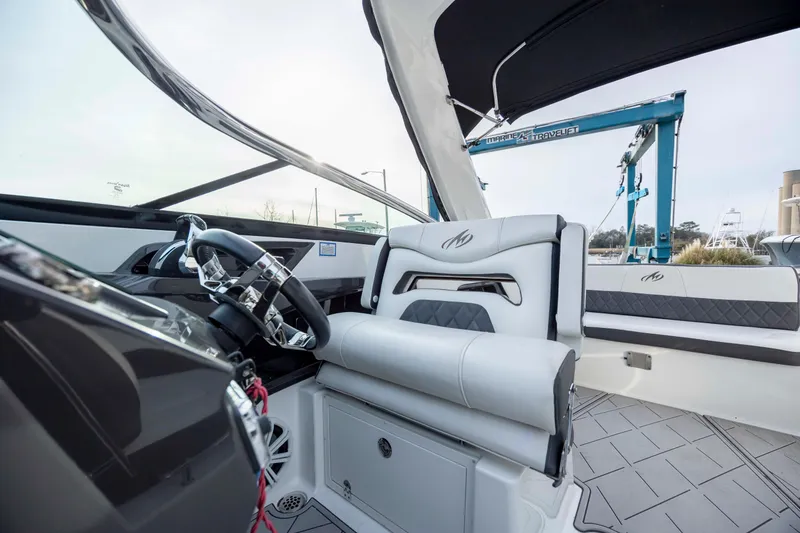 Slide: The Image of 2015 Monterey 328SS Super Sport boat interior with sleek design and modern steering wheel. - 20