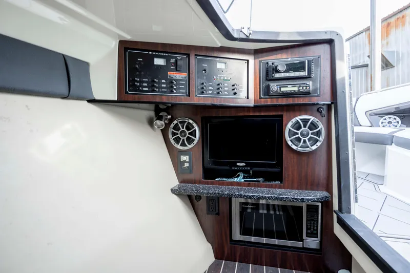 Slide: The Image of Control panel of 2015 Monterey 328SS Super Sport boat with audio system and microwave. - 29