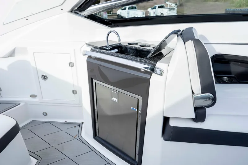 Slide: The Image of 2015 Monterey 328SS Super Sport boat interior with sleek kitchenette and modern design. - 30