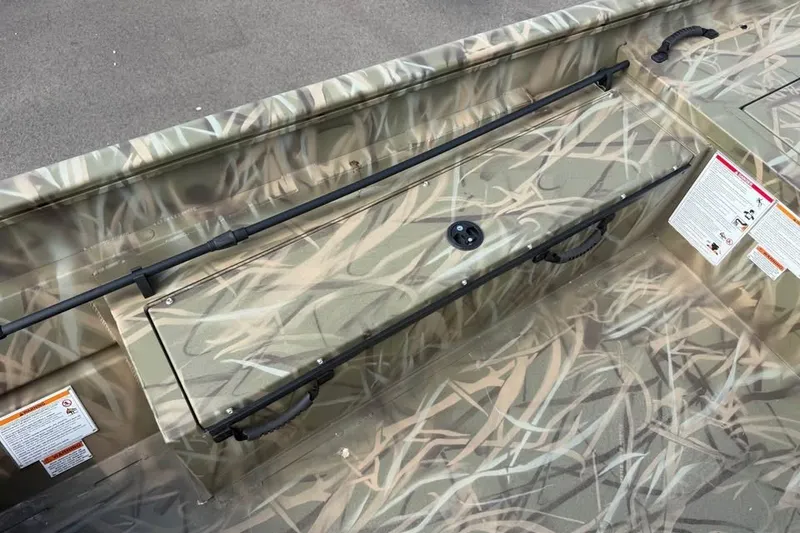 Slide: The Image of Crestliner 2070 Retriever SCHD 2026 boat interior with camouflage design and storage compartment. - 9