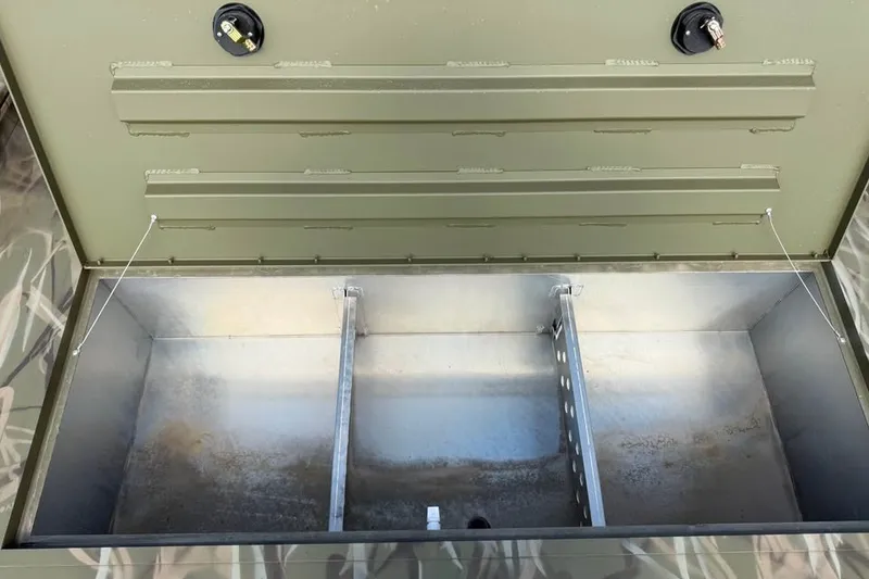 Slide: The Image of Storage compartment of 2026 Crestliner 2070 Retriever SCHD boat, featuring divided sections. - 12