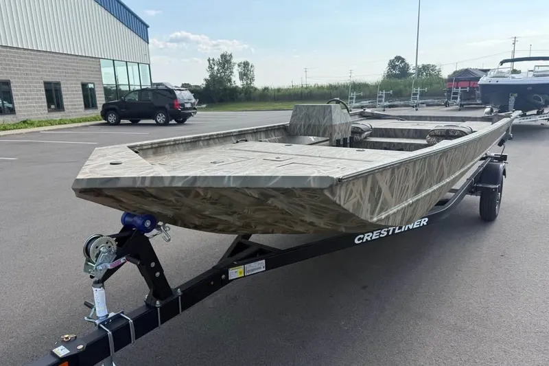 Slide: The Image of 2026 Crestliner 2070 Retriever SCHD boat on trailer in parking lot. - 6