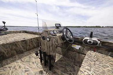 Slide: The Image of Manufacturer Provided Image: 2026 Crestliner 2070 Retriever SCHD boat with camouflage interior on a lake. - 19