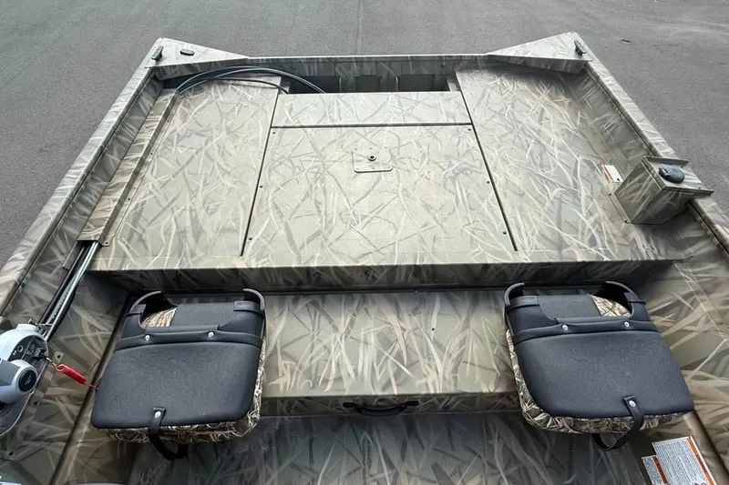 Slide: The Image of 2026 Crestliner 2070 Retriever SCHD boat interior with camouflage design and seating. - 7