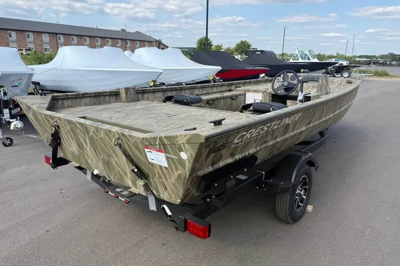 Slide: The Image of 2026 Crestliner 2070 Retriever SCHD boat in camouflage design on a trailer. - 5