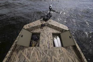 Slide: The Image of Manufacturer Provided Image: Crestliner 2070 Retriever SCHD 2026 boat with camo design and storage compartments on water. - 17