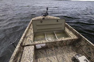 Slide: The Image of Manufacturer Provided Image: 2026 Crestliner 2070 Retriever SCHD boat with camouflage design on open water. - 18