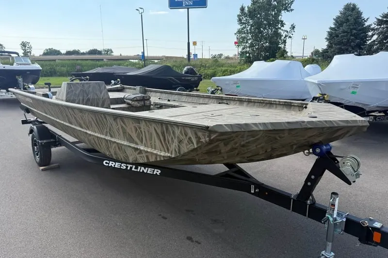 Slide: The Image of 2026 Crestliner 2070 Retriever SCHD boat on trailer, featuring camouflage design. - 1