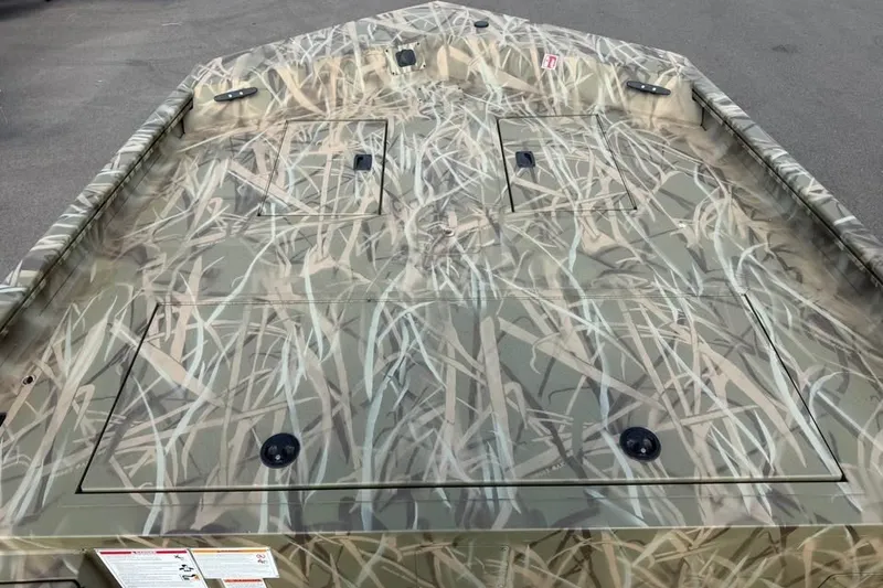Slide: The Image of 2026 Crestliner 2070 Retriever SCHD boat with camouflage design on deck. - 8