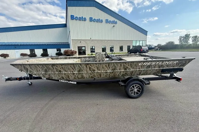 Slide: The Image of 2026 Crestliner 2070 Retriever SCHD boat on trailer, parked outside dealership. - 2